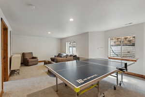 Recreation room featuring carpet flooring, recessed lighting, visible vents, and baseboards