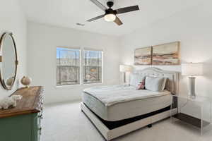 Bedroom with carpet, visible vents, and a ceiling fan