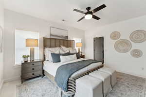 Carpeted bedroom featuring visible vents, ceiling fan, and baseboards