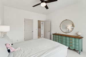 Bedroom featuring ceiling fan and carpet flooring