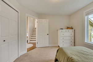 Bedroom featuring carpet flooring and baseboards