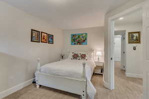 Bedroom featuring carpet flooring and baseboards