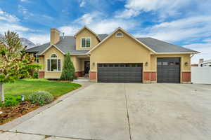 Craftsman-style home with stucco siding, concrete driveway, a front lawn, and a garage
