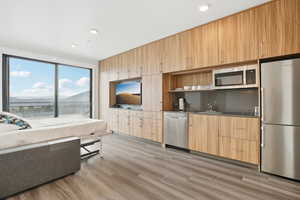 Living area featuring recessed lighting and light wood-type flooring