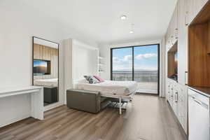 Bedroom with light wood-type flooring, recessed lighting, and access to exterior