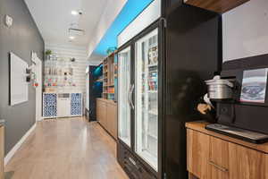 Corridor with recessed lighting and light wood finished floors