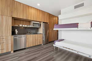 Kitchen featuring a sink, modern cabinets, stainless steel appliances, open shelves, and visible vents