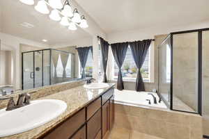 Full bath featuring tile patterned floors, visible vents, a shower stall, and a sink