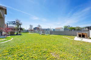 View of yard with a fenced backyard and a playground