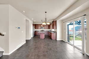 Kitchen featuring recessed lighting, an inviting chandelier, visible vents, a kitchen island, and appliances with stainless steel finishes