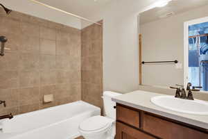 Bathroom with visible vents, bathing tub / shower combination, toilet, and vanity