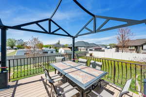 Wooden deck featuring a fenced backyard, a yard, a residential view, and outdoor dining area