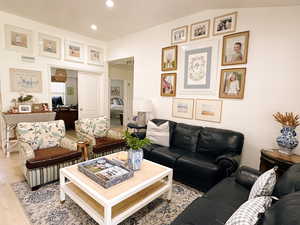Living room with light wood finished floors and recessed lighting