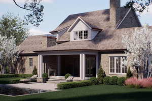 Back of property featuring a chimney, stone siding, a lawn, and a patio area