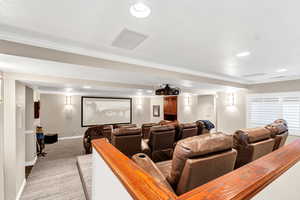 Home theater featuring baseboards, recessed lighting, light colored carpet, and crown molding