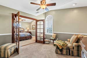 Bedroom featuring vaulted ceiling, visible vents, carpet, and ceiling fan