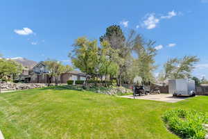 View of yard featuring a patio, fence, and a mountain view