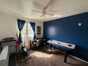 Game room with ceiling fan and baseboards