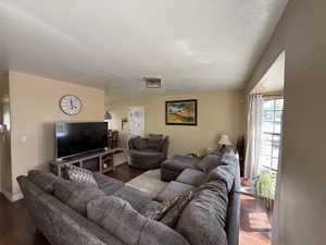 Living area featuring baseboards and wood finished floors
