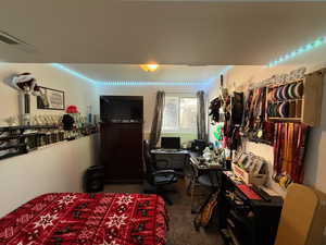 Bedroom featuring visible vents and carpet floors