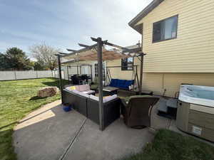 View of patio / terrace with outdoor lounge area, fence, a hot tub, and a pergola