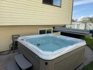 Exterior space featuring fence and a hot tub