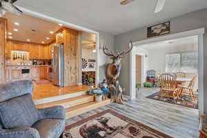 Living area with ceiling fan, recessed lighting, light wood-style flooring, and baseboards