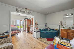 Misc room with light wood finished floors and visible vents