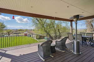 Deck with outdoor dining space and a yard