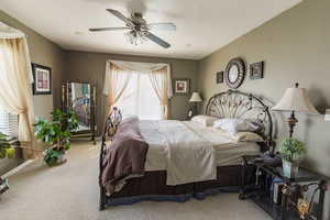 Bedroom with baseboards, a ceiling fan, and carpet floors