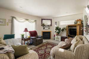 Carpeted living room with a fireplace with flush hearth