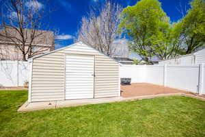 View of shed with a fenced backyard