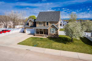 Traditional home featuring stucco siding, fence, covered porch, and concrete driveway