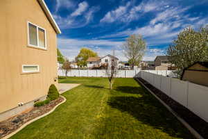View of yard featuring a fenced backyard and a residential view