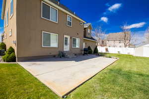 Rear view of house featuring a patio, crawl space, a yard, entry steps, and fence