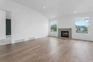 Unfurnished living room featuring visible vents and light wood finished floors