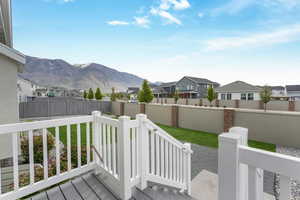 Exterior space featuring a mountain view, a residential view, and a fenced backyard