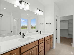 Full bathroom with tile patterned flooring, recessed lighting, double vanity, and a sink