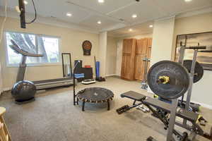 Workout area with recessed lighting, coffered ceiling, and baseboards