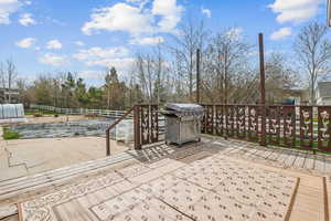 Exterior space featuring grilling area, fence, and a deck