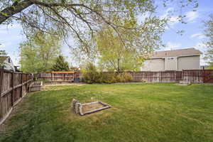 View of yard with a garden and a fenced backyard