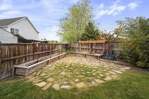 View of yard featuring a vegetable garden and a fenced backyard