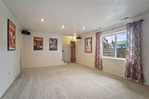 Empty room featuring visible vents, stairway, crown molding, and recessed lighting