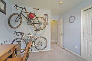 Interior space featuring a textured ceiling, visible vents, and baseboards