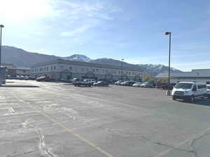 Uncovered parking lot featuring a mountain view