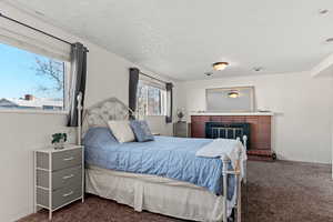 Family room with carpet,  brick fireplace,  currently being used as a bedroom