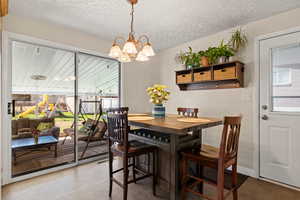 Dining space with door to back yard and patio, including another door to carport