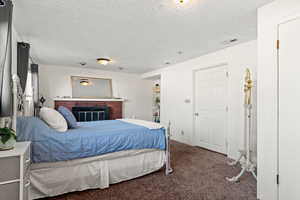 Family room with carpet,  brick fireplace,  currently being used as a bedroom