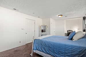 Family room with carpet,  brick fireplace,  currently being used as a bedroom