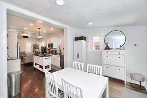 Multi-purpose dining space featuring hardwood floors, plenty of natural light, and recessed lighting